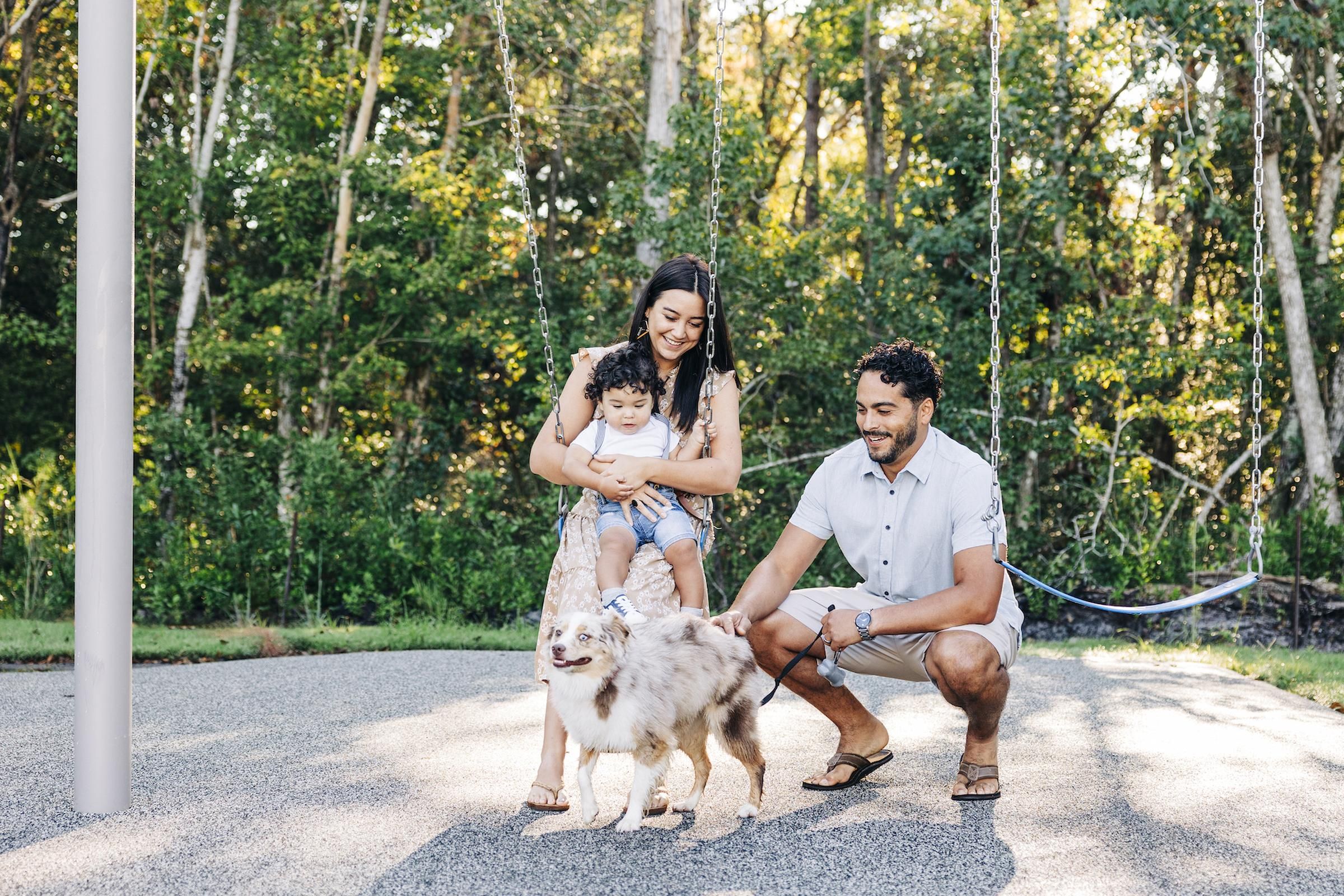 Evolve Grove Park A family enjoying a sunny day in the park with their dog, surrounded by greenery and playful atmosphere.